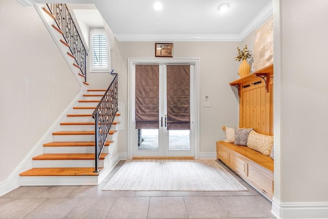 tiled entrance foyer featuring ornamental molding and french doors