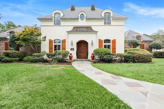 french provincial home featuring a front lawn