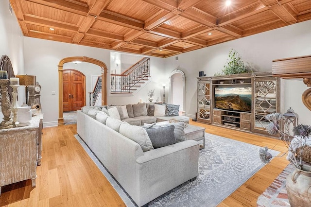 living room with wood ceiling, coffered ceiling, light hardwood / wood-style floors, and beamed ceiling