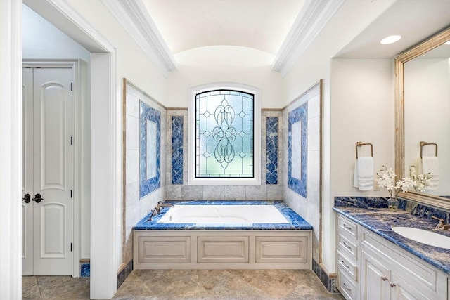 bathroom with vanity, a bathtub, vaulted ceiling, and crown molding