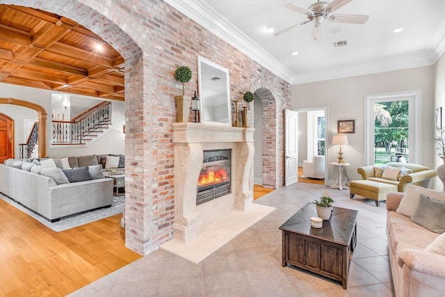 living room featuring crown molding, coffered ceiling, light tile patterned floors, and wood ceiling