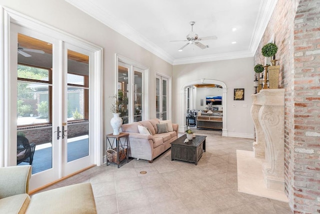 living room with french doors, ceiling fan, ornamental molding, and light tile patterned floors