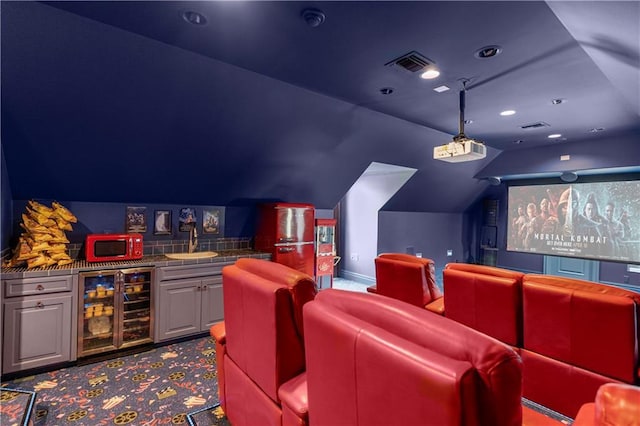 carpeted cinema with vaulted ceiling, bar, and wine cooler