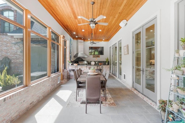 sunroom featuring wooden ceiling, ceiling fan, and french doors