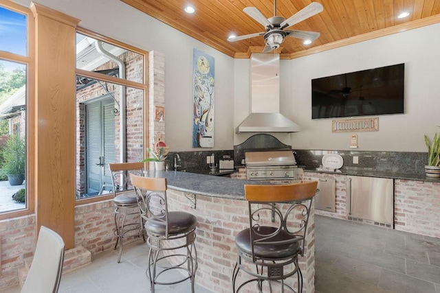 interior space featuring crown molding, brick wall, wood ceiling, and wall chimney exhaust hood