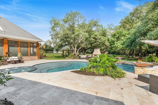 view of pool featuring a fireplace and a patio area