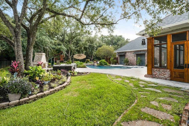 view of yard with a fireplace and a patio area