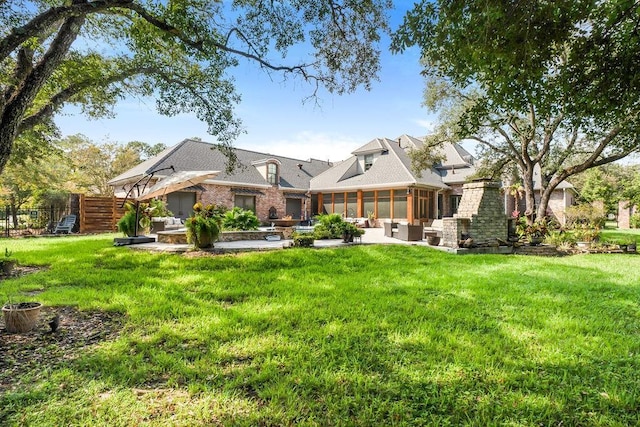 back of house featuring outdoor lounge area, a yard, and a patio area