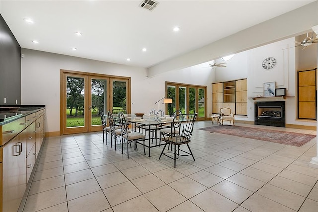 tiled dining room featuring ceiling fan, french doors, and a wealth of natural light