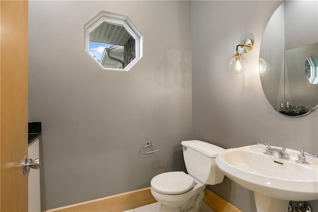 bathroom featuring toilet and sink