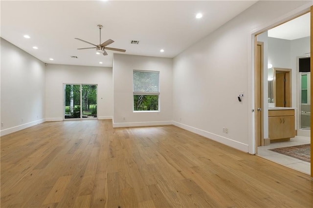 unfurnished living room with light wood-type flooring and ceiling fan