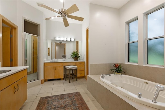 bathroom with shower with separate bathtub, vanity, ceiling fan, and tile patterned floors