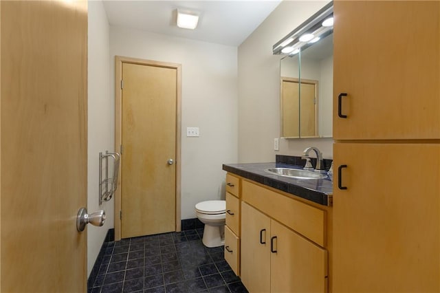 bathroom featuring vanity, toilet, and tile patterned floors