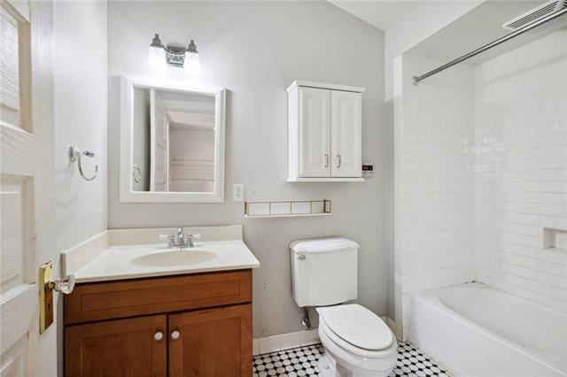 full bathroom featuring toilet, tiled shower / bath combo, and vanity