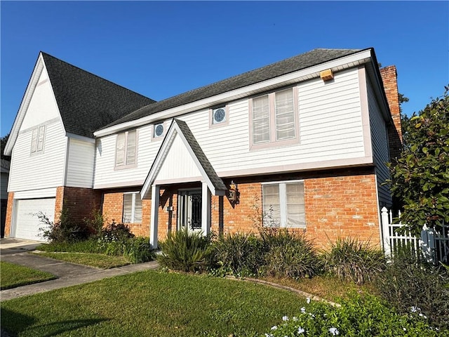 view of front of house with a garage and a front lawn