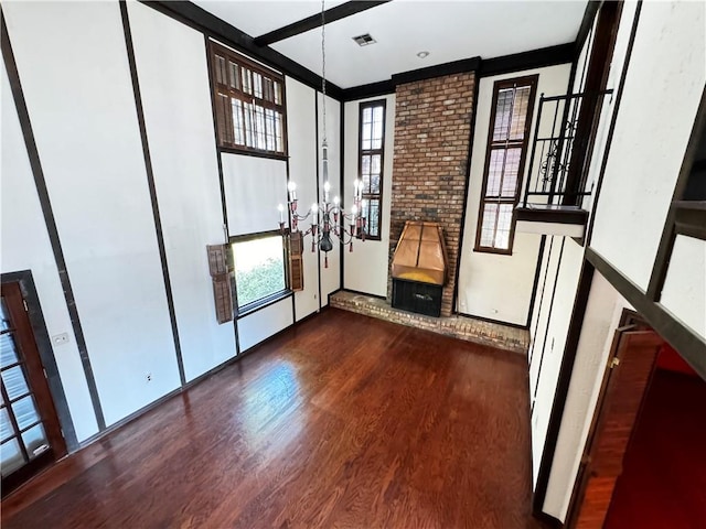 interior space with an inviting chandelier, a wealth of natural light, and dark wood-type flooring