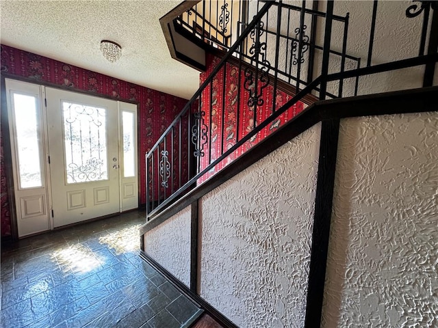 foyer featuring a textured ceiling