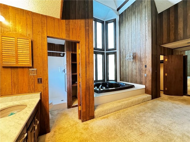 full bathroom with shower with separate bathtub, lofted ceiling, wooden walls, vanity, and toilet