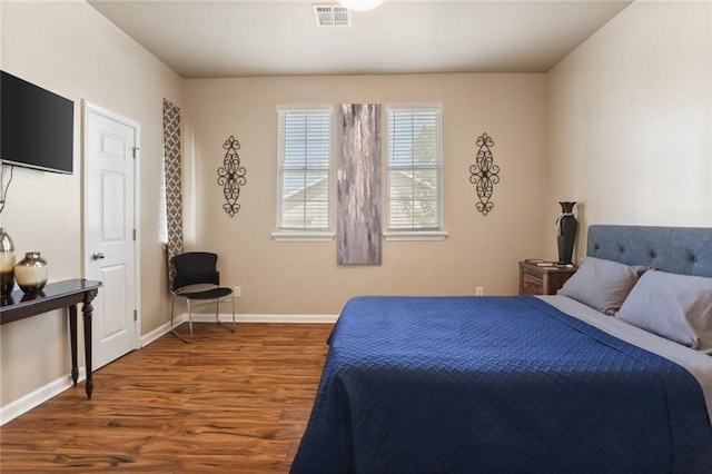 bedroom with wood-type flooring