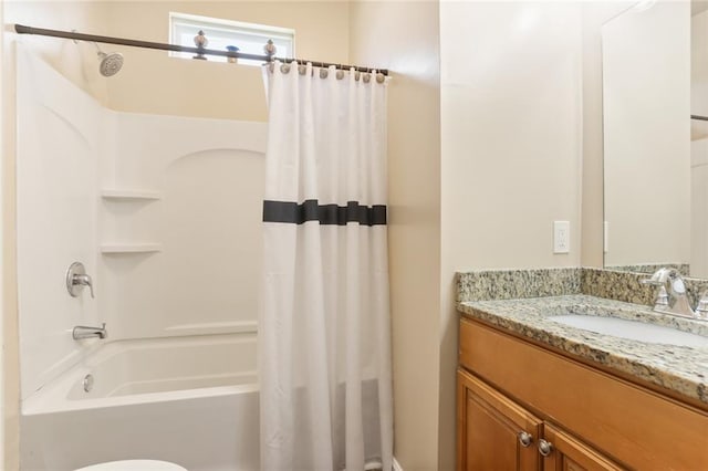 full bathroom with shower / tub combo with curtain, vanity, and toilet