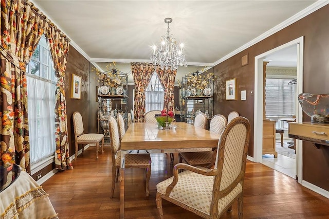 dining room with wood-type flooring, a notable chandelier, and a wealth of natural light