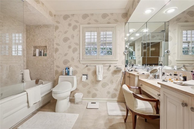 bathroom featuring ornamental molding, a bathing tub, vanity, and toilet