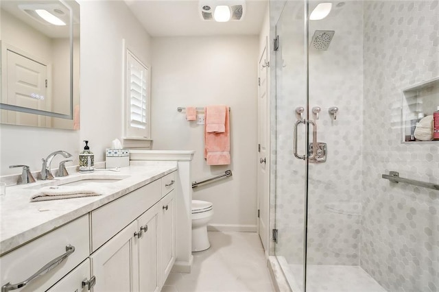 bathroom with vanity, toilet, and an enclosed shower