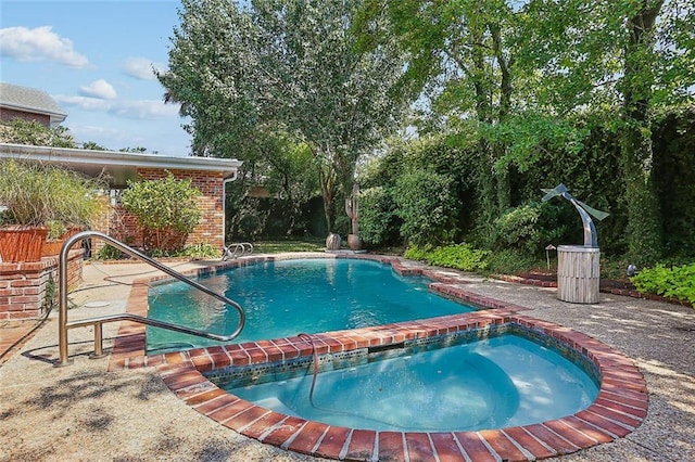 view of swimming pool with an in ground hot tub