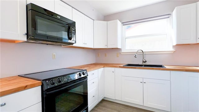 kitchen featuring white cabinetry, sink, and black appliances