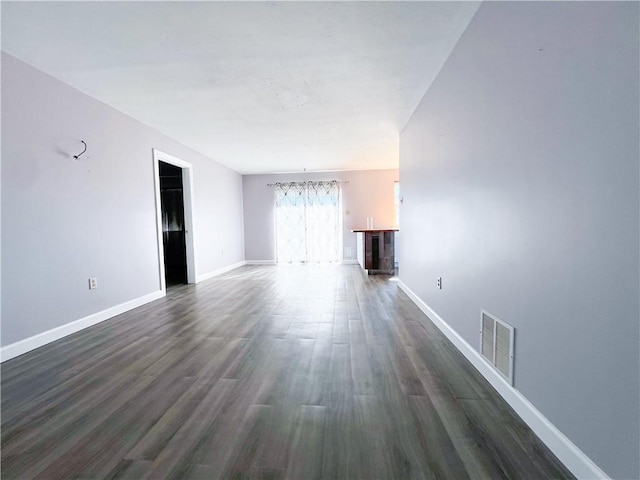 unfurnished living room featuring dark hardwood / wood-style floors