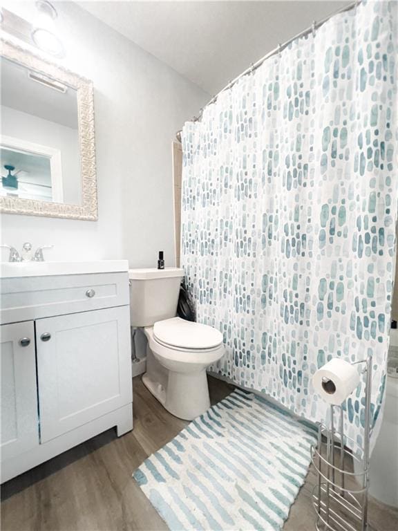 bathroom featuring hardwood / wood-style flooring, vanity, and toilet