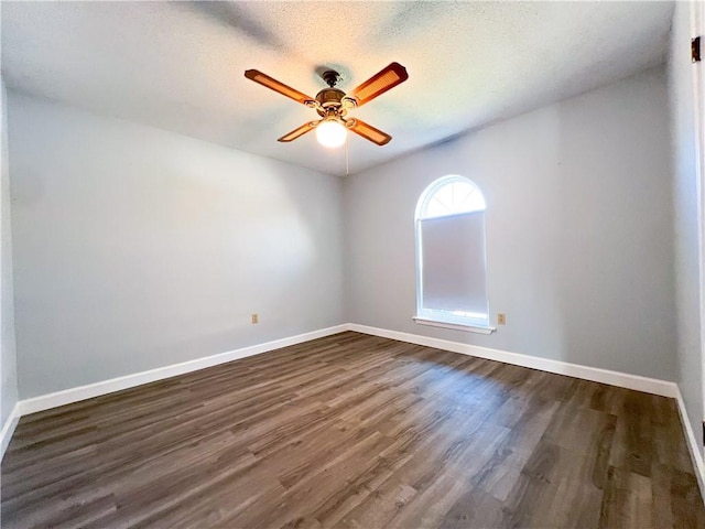 spare room featuring a textured ceiling, dark hardwood / wood-style flooring, and ceiling fan