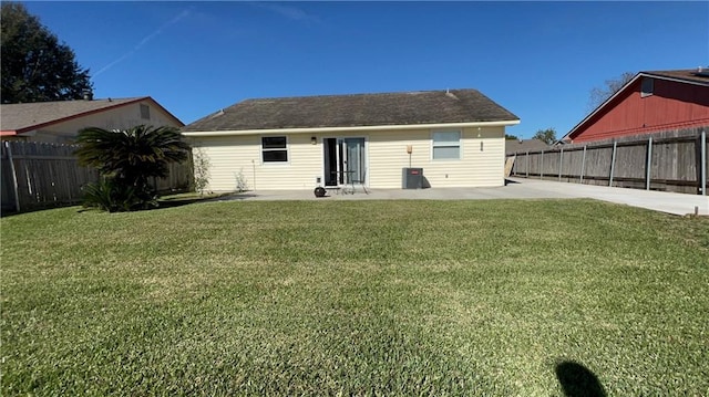 back of property with a lawn and a patio area