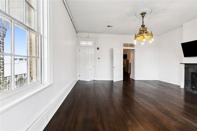 unfurnished living room with dark hardwood / wood-style flooring