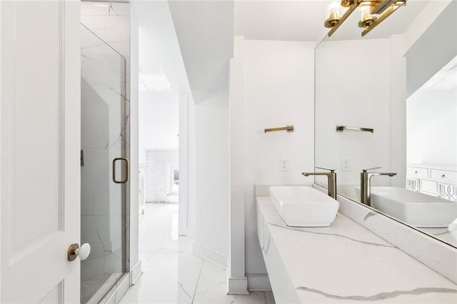 bathroom with vanity and a shower with door