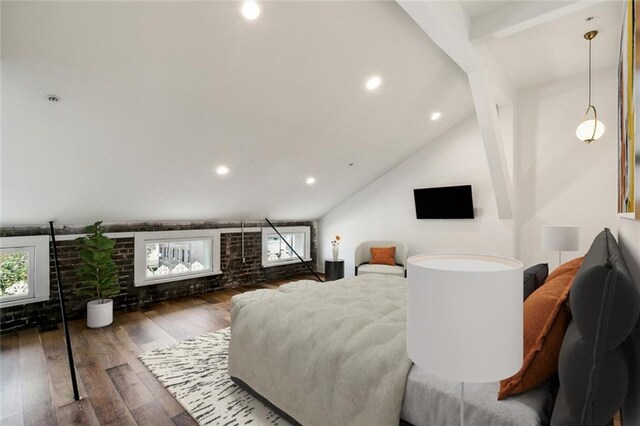 living room featuring hardwood / wood-style flooring, a healthy amount of sunlight, and vaulted ceiling with beams