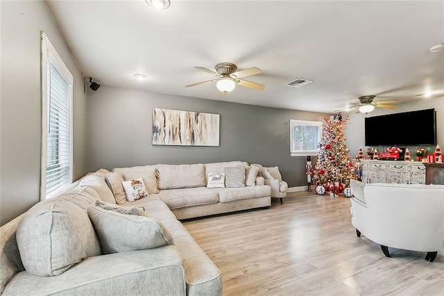 living room with ceiling fan and light wood-type flooring