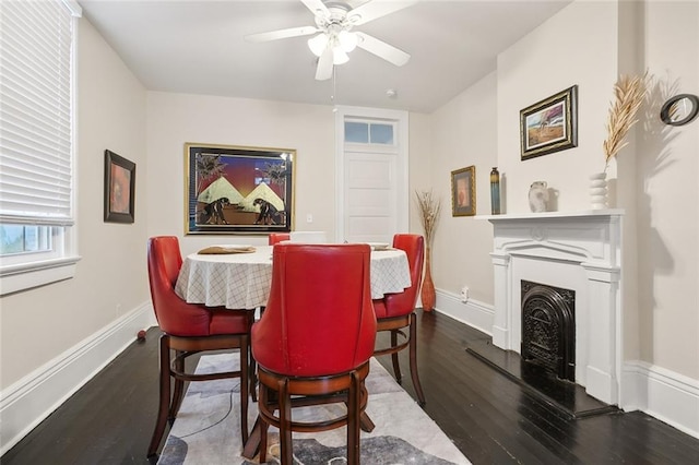 dining space featuring ceiling fan and dark wood-type flooring