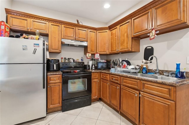 kitchen featuring black appliances, light tile patterned flooring, and sink