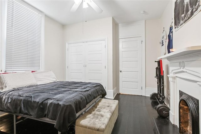 bedroom with dark hardwood / wood-style flooring and ceiling fan