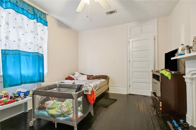 bedroom with ceiling fan and dark hardwood / wood-style flooring