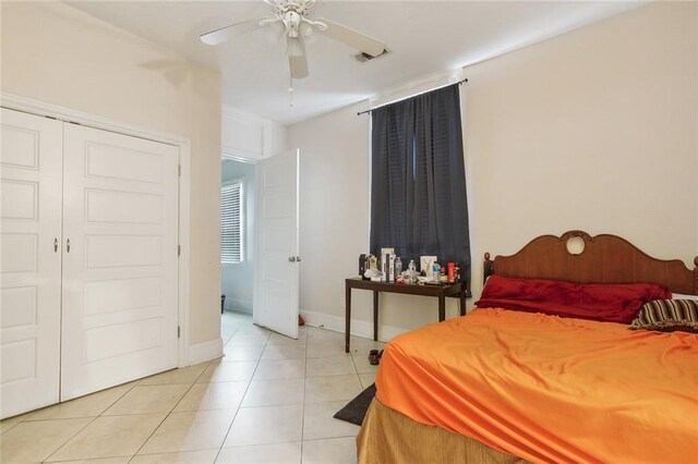 bedroom featuring a closet, ceiling fan, and light tile patterned floors