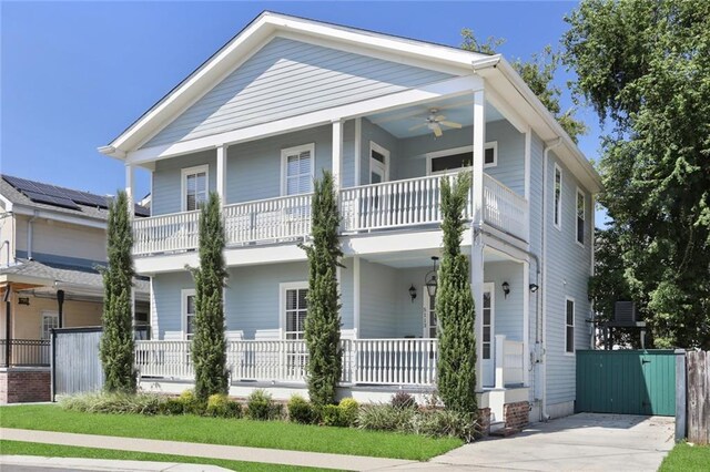 view of front of house with ceiling fan, a balcony, and a porch