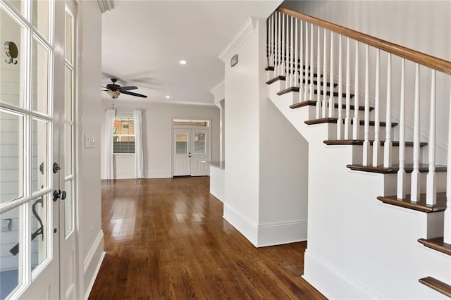 foyer entrance with dark hardwood / wood-style floors, ceiling fan, and french doors