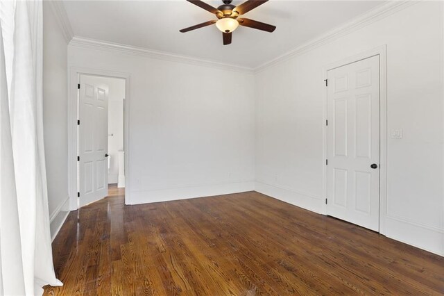 unfurnished room with ceiling fan, dark hardwood / wood-style floors, and ornamental molding