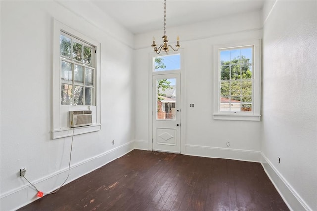 interior space featuring dark hardwood / wood-style floors, an inviting chandelier, and cooling unit