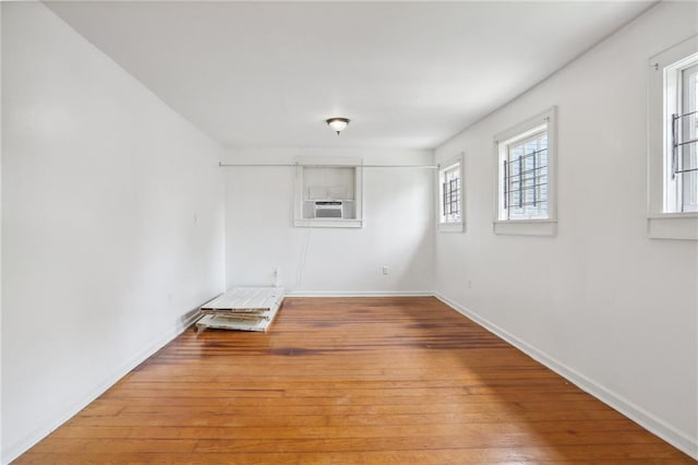 spare room with cooling unit and light wood-type flooring