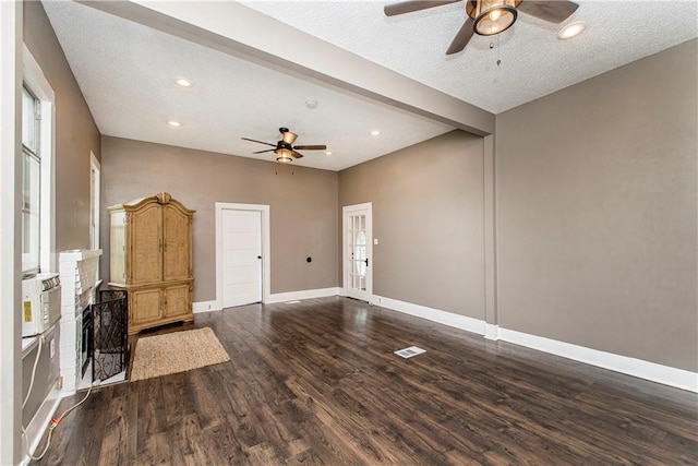 unfurnished living room with a textured ceiling, hardwood / wood-style floors, and ceiling fan