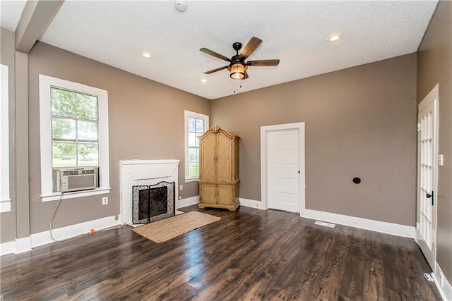 unfurnished living room featuring a textured ceiling, cooling unit, dark hardwood / wood-style floors, and ceiling fan