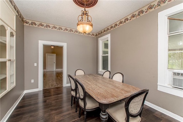 dining space with a textured ceiling and dark hardwood / wood-style flooring